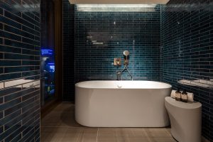 luxurious freestanding bath by Bette in midnight blue bathroom at The Standard