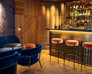traditional wooden floors with dark blue seating add a note of luxury in the James Joyce Bar