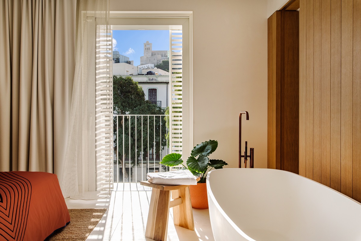 freestanding bath in the guestroom at The Standard Ibiza with a view out to the balcony