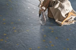 gold star on a blue tile with plaster like finish inspired by Italy