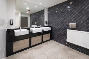 black tiles vertically up the walls by CTD tiles in the washroom at Melia Innside Newcastle