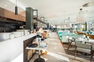 wood inspired tiles and natural tones by CTD Architectural Tiles with turquoise highlights in the gino D'Acampo restaurant in Newcastle