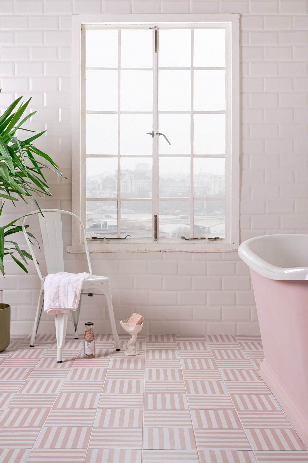 putting the stripes of a deckchair onto a tile in pretty pink bathroom