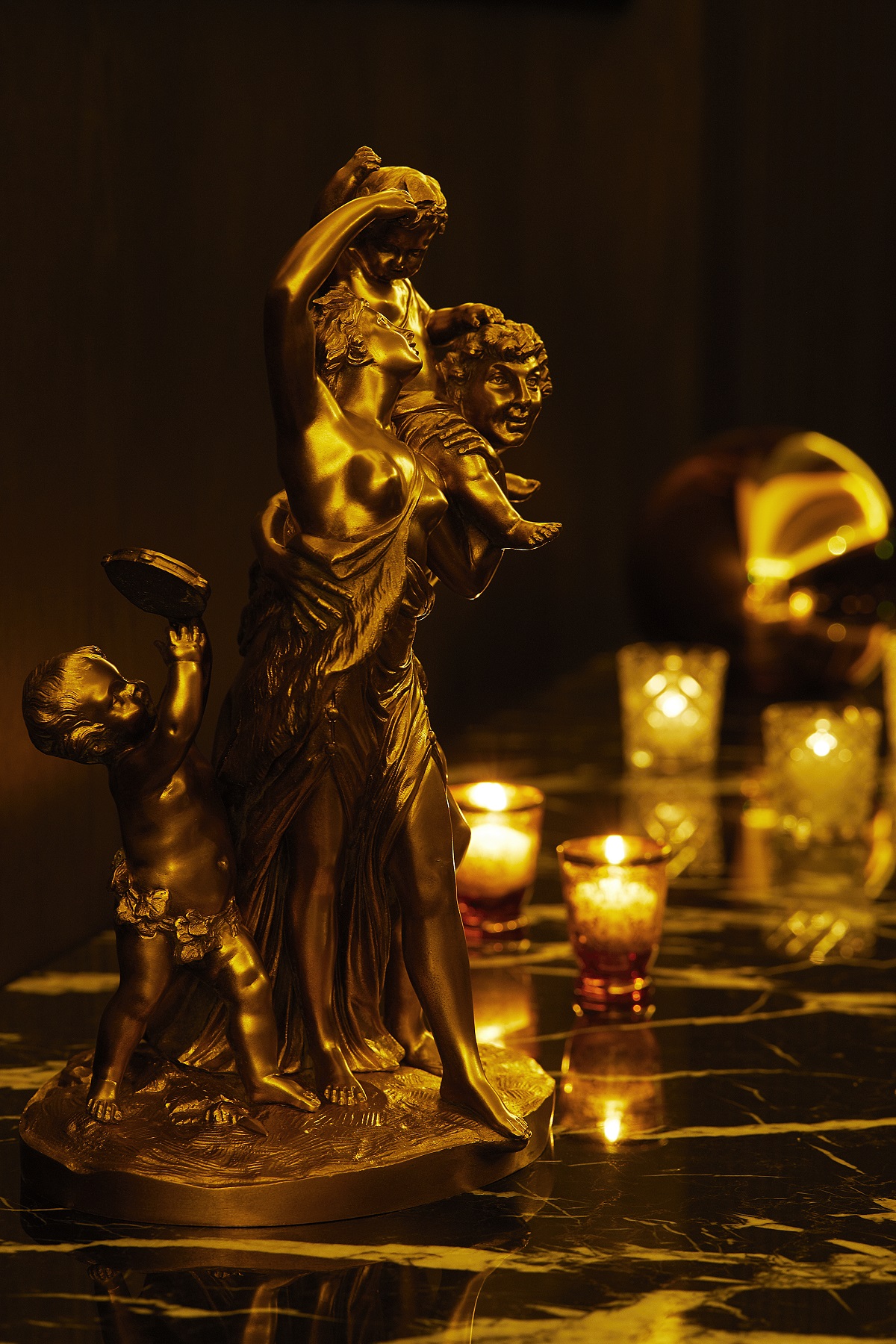 opulent gold details, candles and statues in the Gold Bar Tokyo