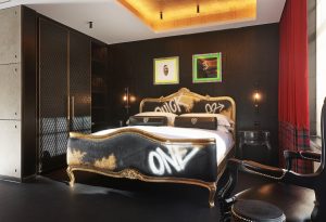 gothic meets punk rock with graffiti bed, black walls and a gold ceiling in Chateau Denmark