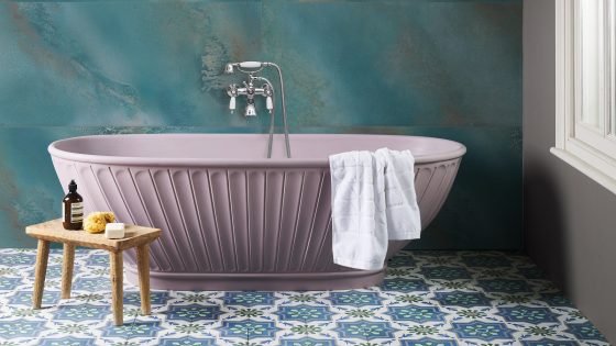 Maldives Lagoon tiles by Hyperion make a feature wall behind the pink freestanding bath