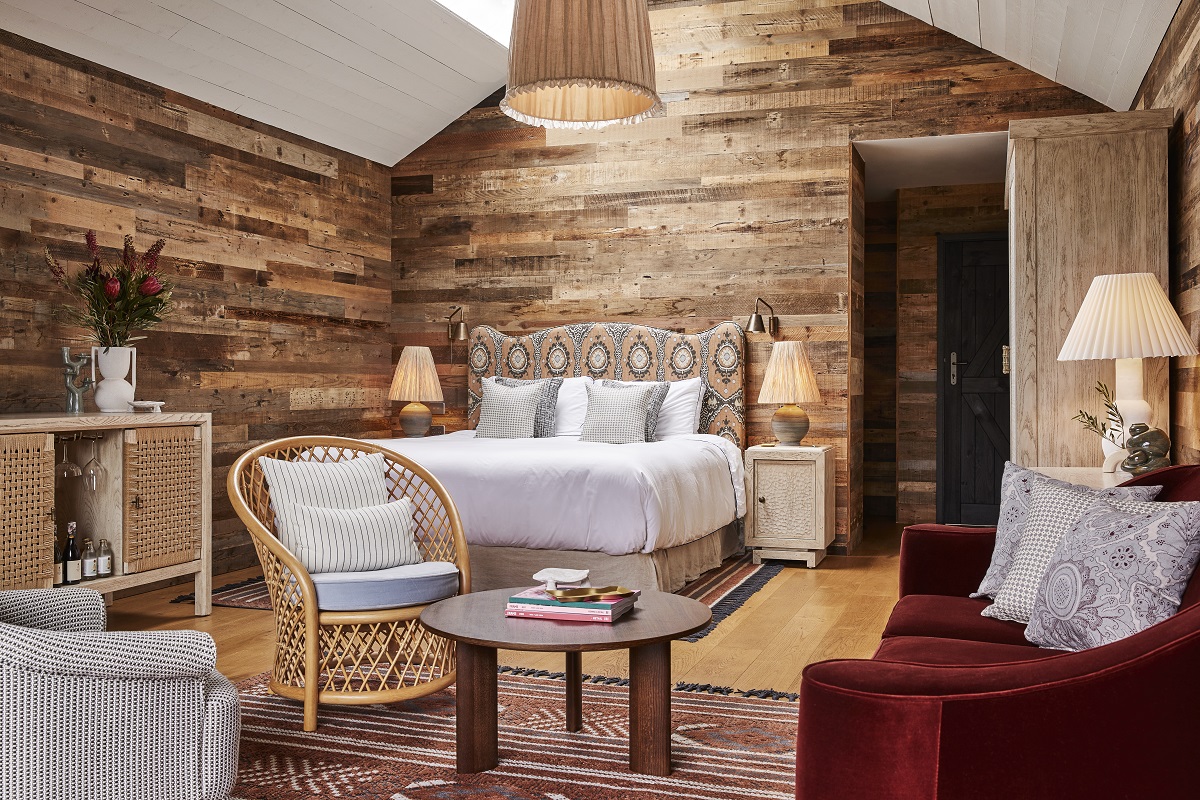 wood panelling with textured rugs and a patterned headboard in a cabin at Osborn House