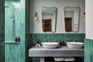 turquoise tiles and vintage mirrors in the bathroom at Osborn House