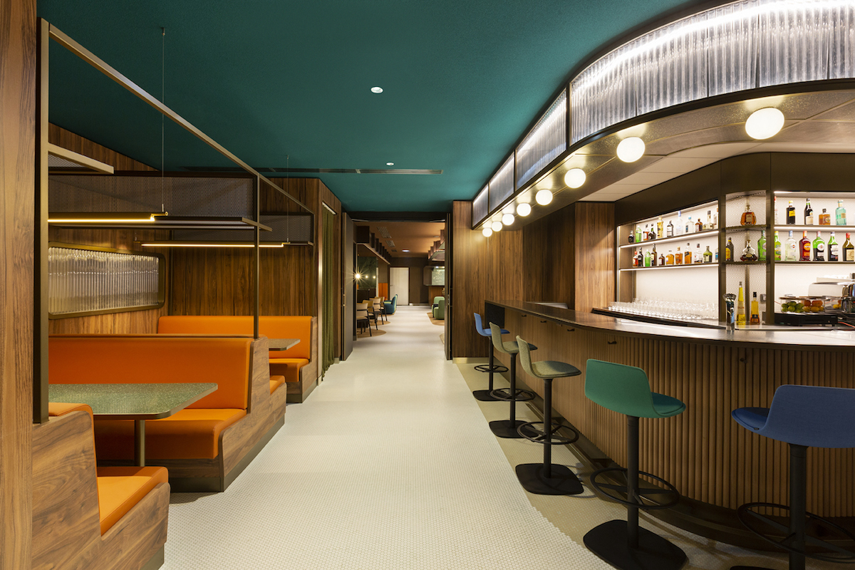A modern restuarant/bar inside Pullman Paris, with green ceiling