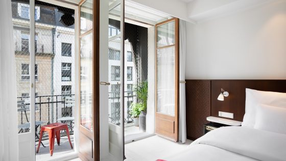 guestroom at Ruby Claire Geneva with doors opening onto balcony in city centre
