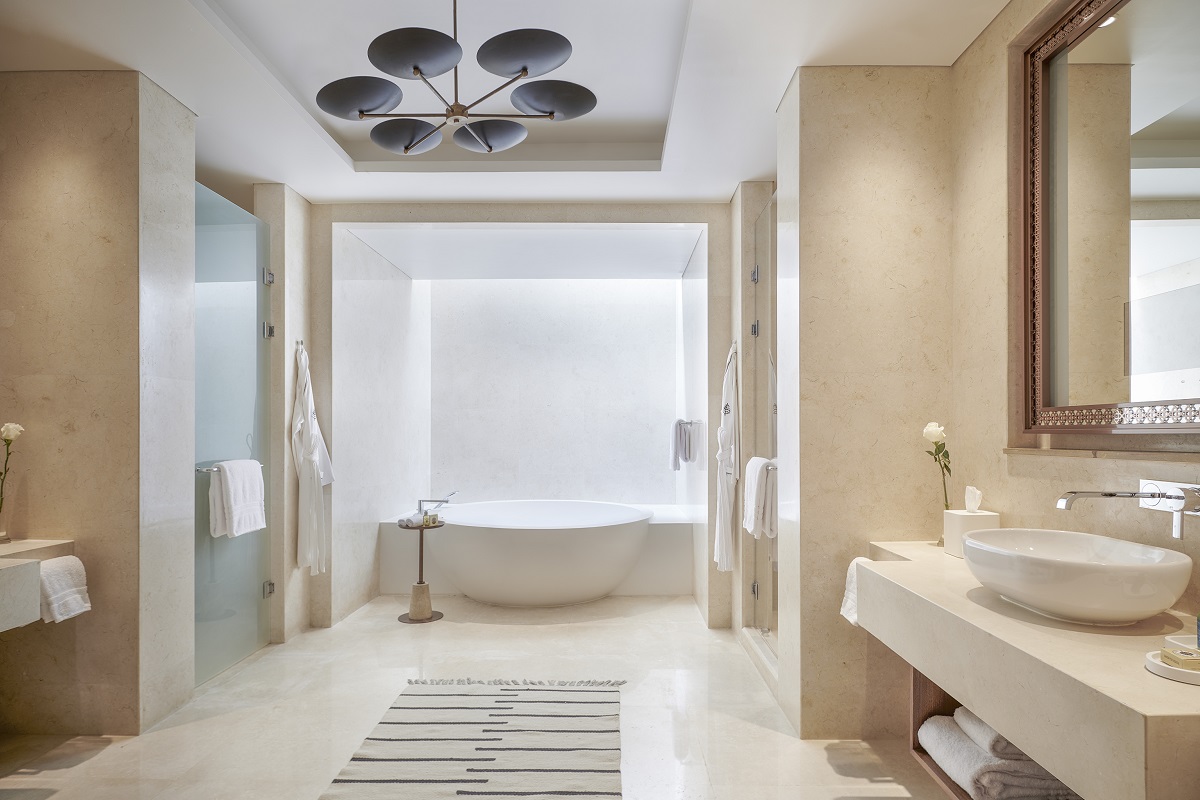 statement bathroom with sculptural bath in white and natural marble