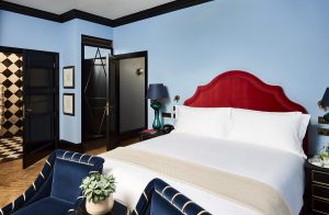 guestroom in signature shades of blue with a contrasting red bed detail
