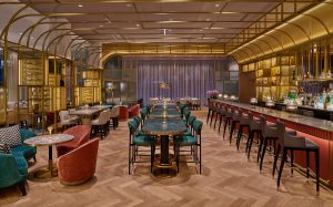 new bar at St Regis with multifunctional seating and design in wood, brass and plush colours