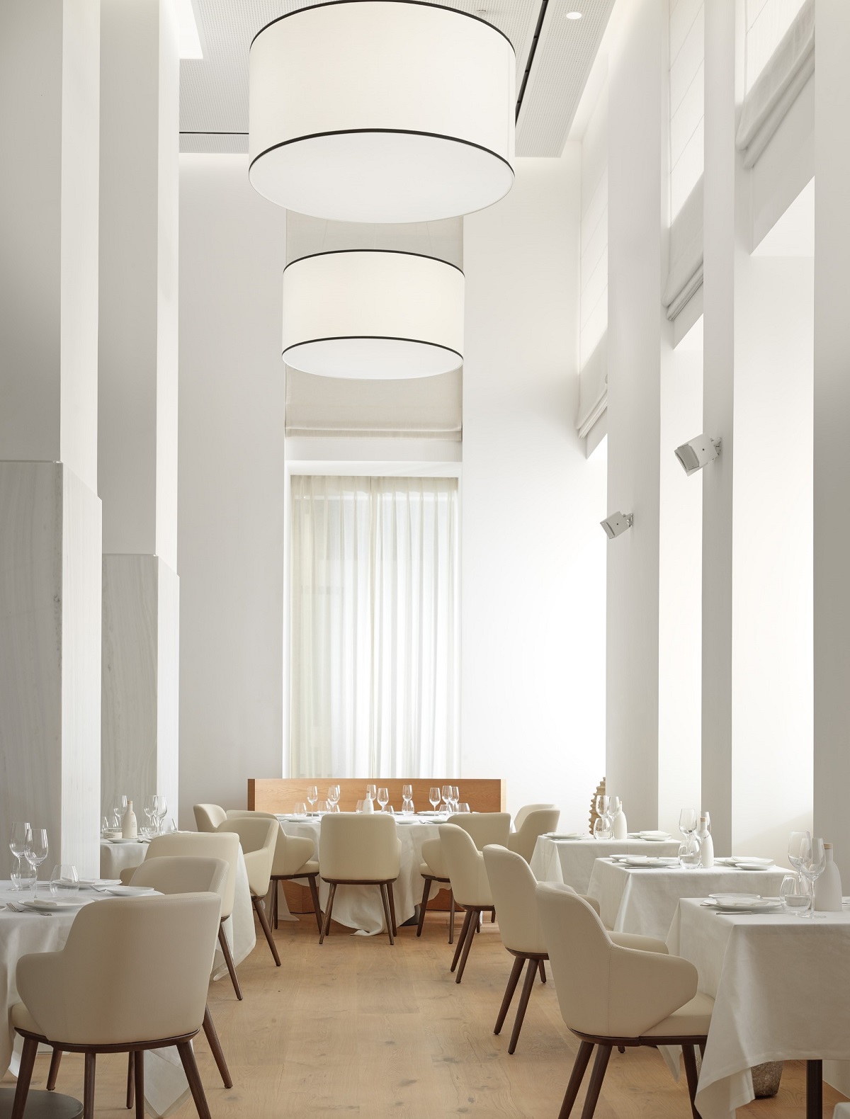 double volume and white on white design make a dramatic statement in the restaurant at xenodocheio milos athens