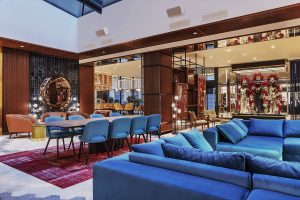 bright blue couches and rockstar memorabilia in the lobby at the Hard Rock Hotel Budapest