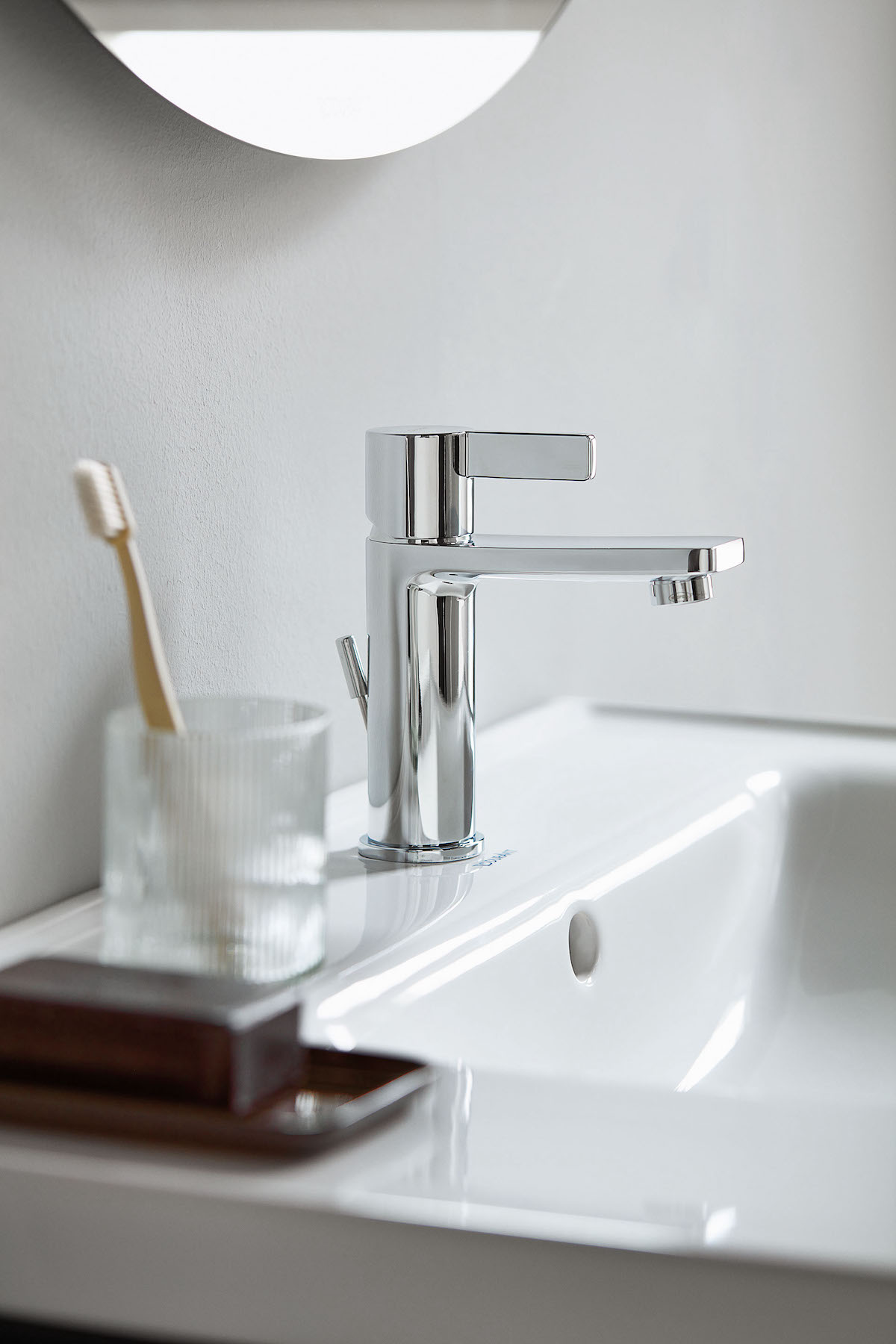 Close-up of tap in modern white bathroom