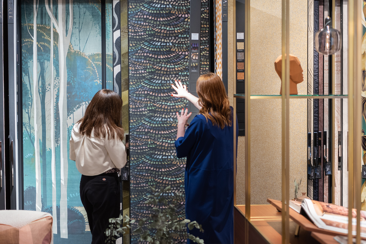 Two women looking at wallcoverings