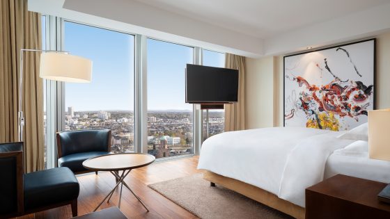 guestroom at JW Marriott Frankfurt with views over the city and an ebersbach painting on the wall