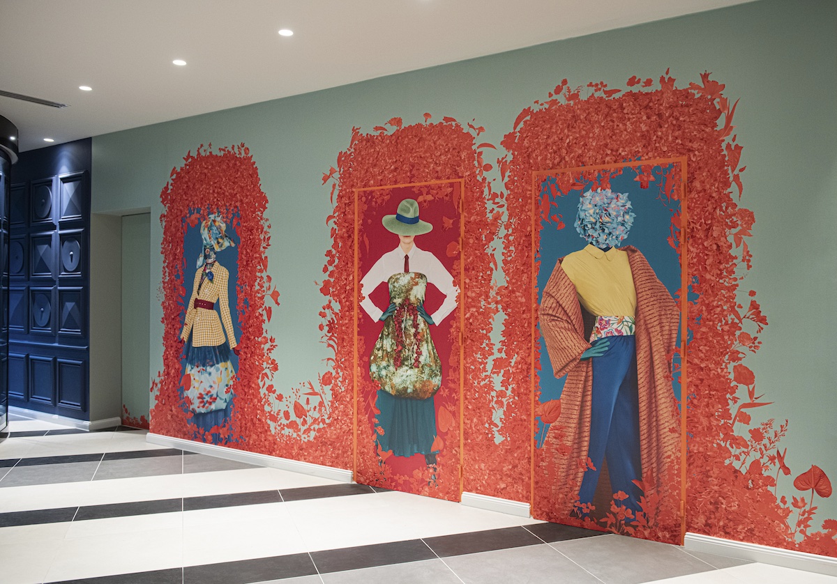 Wallcovering in hotel of three women in arch and flowers