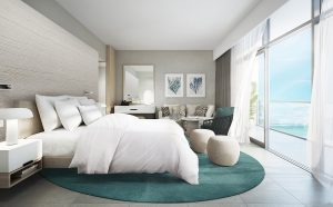 contemporary interior in white and blue with a sea view at Movenpick resort al marjan