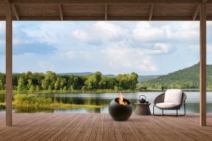 round metal bubble fireplace by Focus on wood terrace overlooking a lake