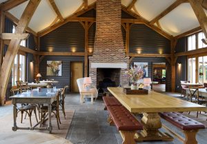 the barn at Retreat East with fireplace at the end of double volume traditional structure