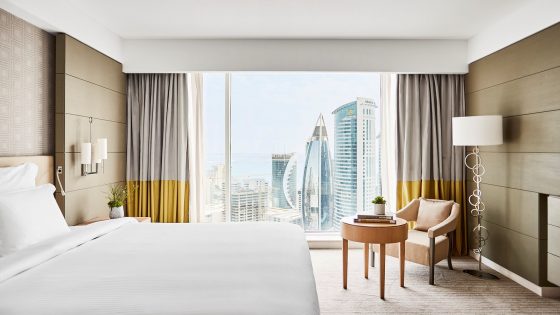 apartment room in the Pullman hotel in Doha decorated in gold and cream with windows looking over city views