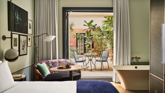 guestroom at Hotel Per La opening onto patio garden