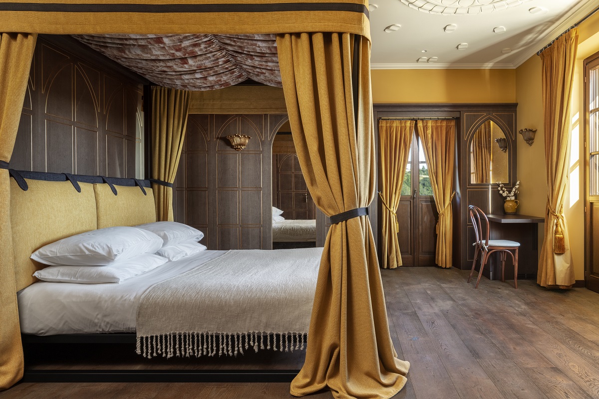 period details and rich gold drapes in guestroom at Nordelaia