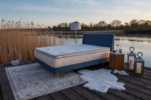 naturalmat mattress on a bed next to a lake