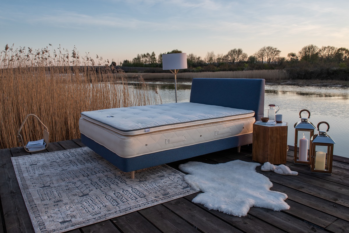 naturalmat mattress on a bed next to a lake