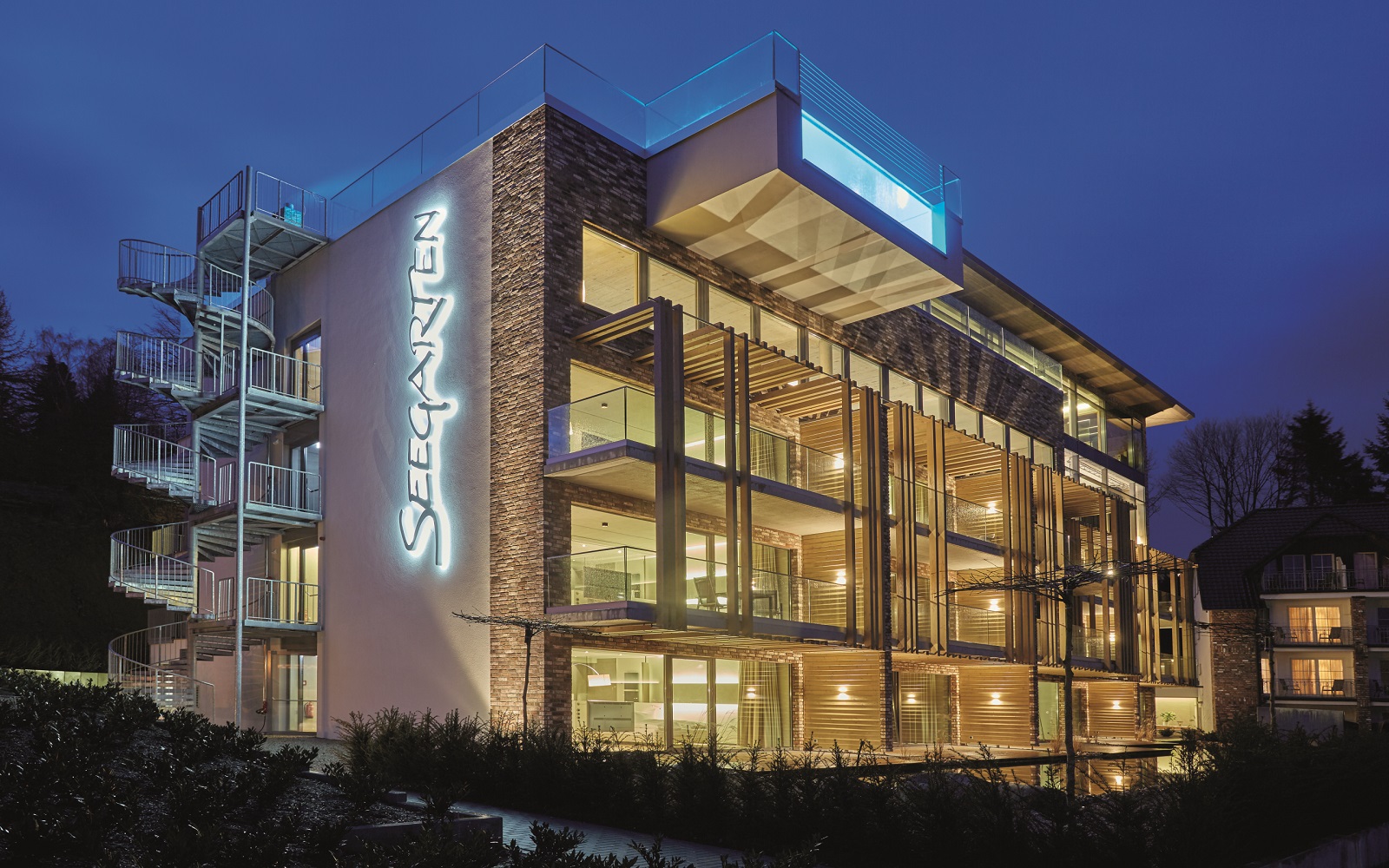 exterior of Hotel Seegarten lit up at night after bathroom redesign with Dornbracht