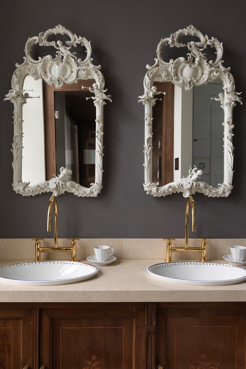 white period mirrors on a grey wall with gold dornbracht taps