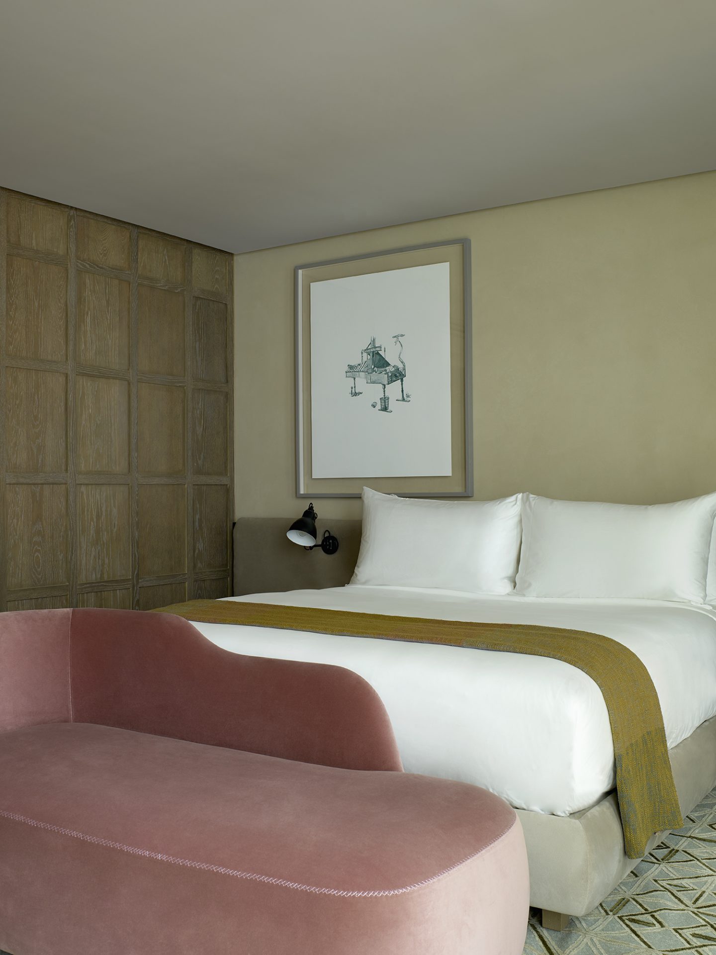 Muted tones and wood paneled walls inside The Londoner guestrooms