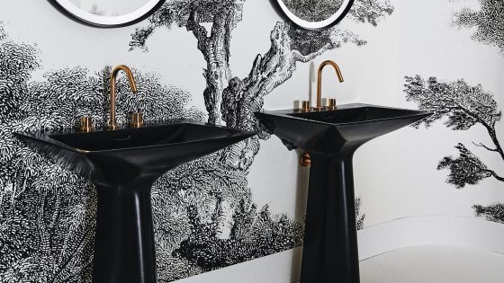 black basin with gold taps by Ideal Standard against a monochromatic wall design in the bathroom