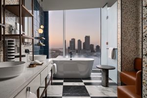 bathtub with a view and seating area in the bathroom of W Dubai design by BLINK