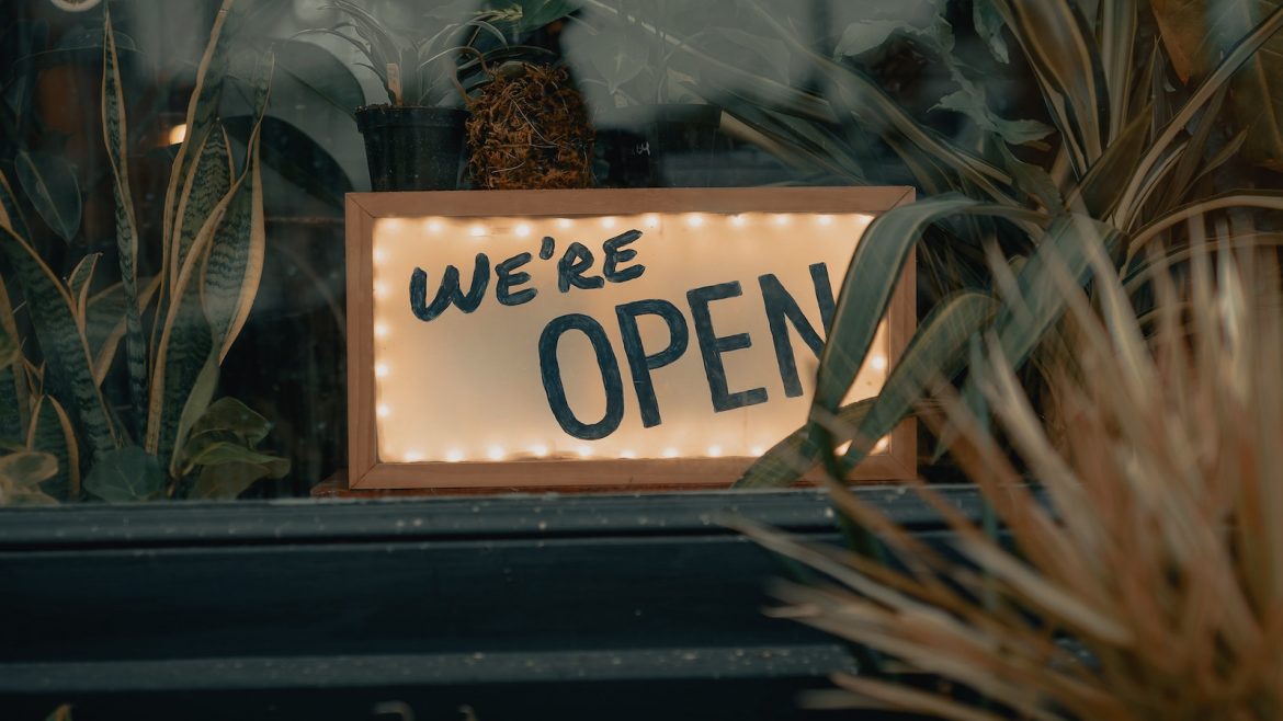 Sign saying 'we are open' in shop window