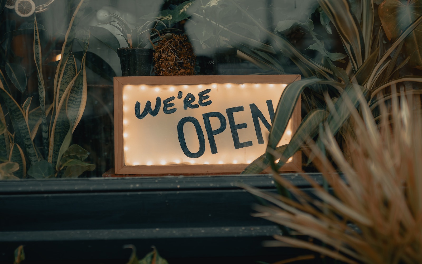 Sign saying 'we are open' in shop window