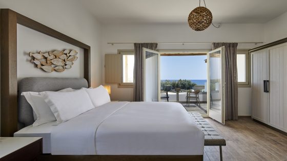 guestroom with french doors onto terrace with seavies at Hilton Santorini