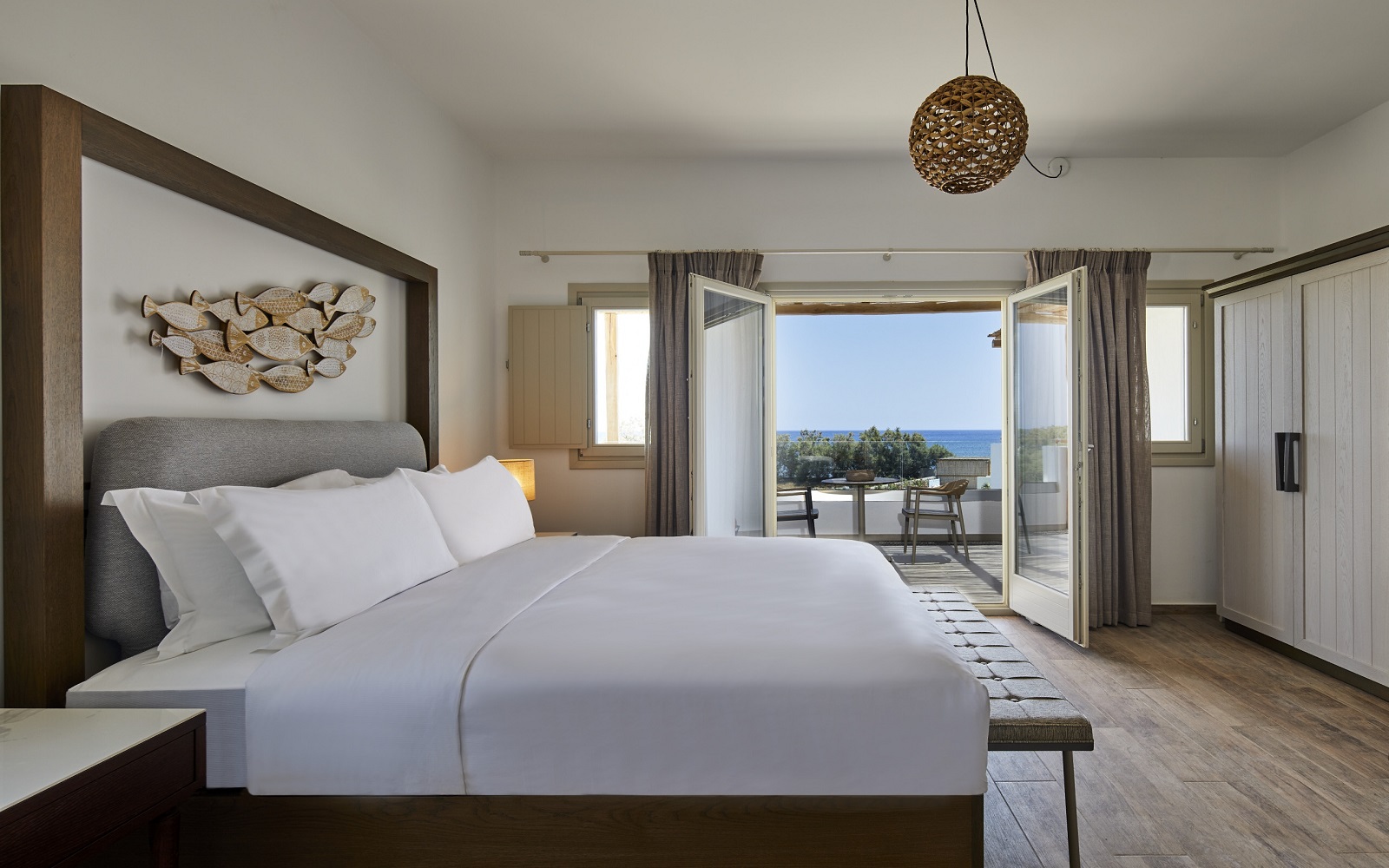 guestroom with french doors onto terrace with seavies at Hilton Santorini