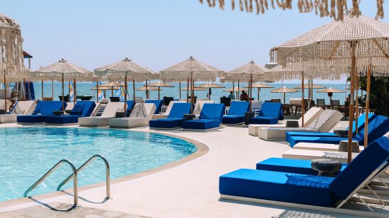 sunbeds and swimming pool at Brown Beach Eretria by Brown Hotels