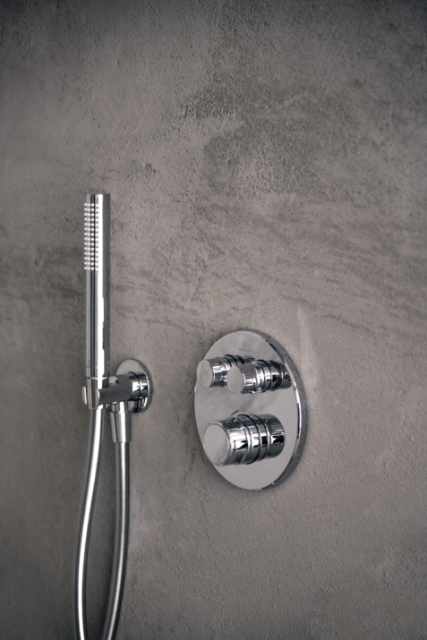chrome shower and control on grey wall by ideal Standard