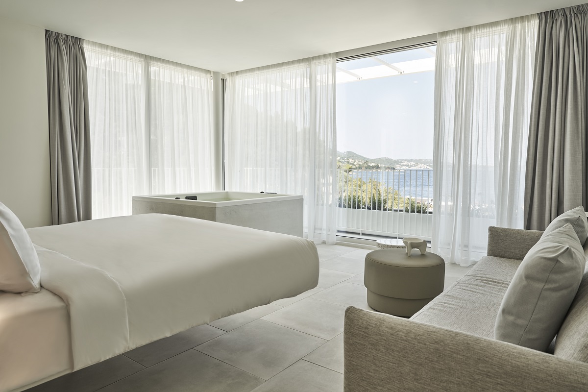 all white decor in the guestrooms at Radisson Resort Plaza Skiathos