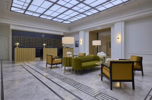 green and gold seating in the lobby at Hotel Saski Krakow Curio Collection by Hilton