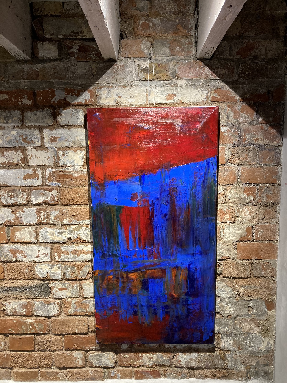 strong colours in art work by Frances Bildner brighten up a brick wall