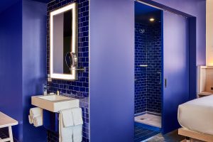guestroom at Radio Hotel New York with bright primary blue bathroom