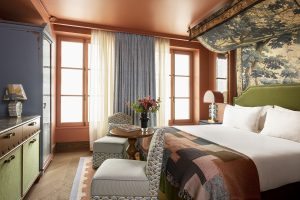 guestroom at Le Grand Mazarin with blue accents and layers of pattern