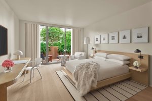 EDITION Tampa guestroom in white and wood with garden view