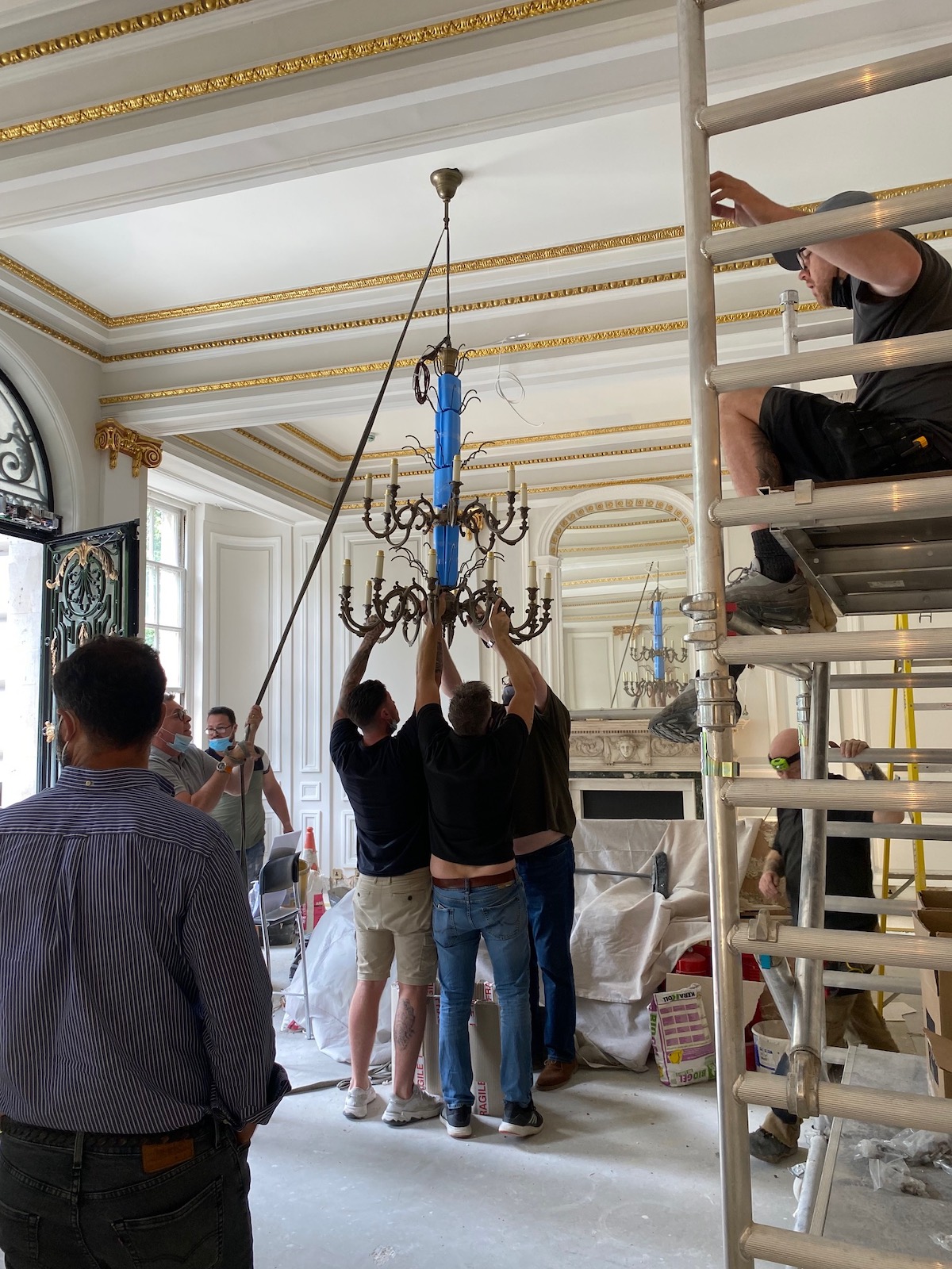 Grosvenor Square installation, men hanging chandelier