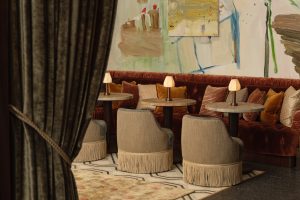 velvet armchairs and contemporary art in the cozy of The Ned NoMad